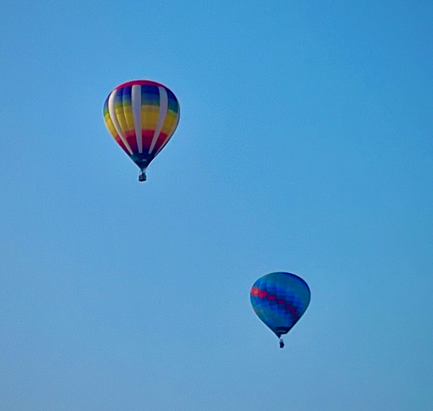 Two hot air balloons in the air.