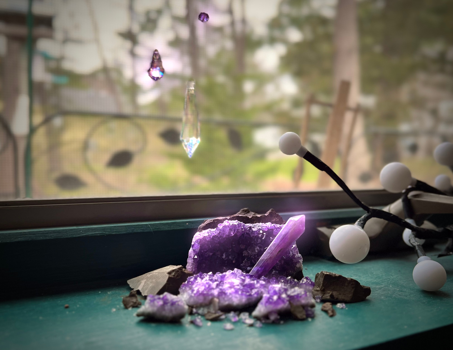 A stone, broken open, revealing amethyst gems.