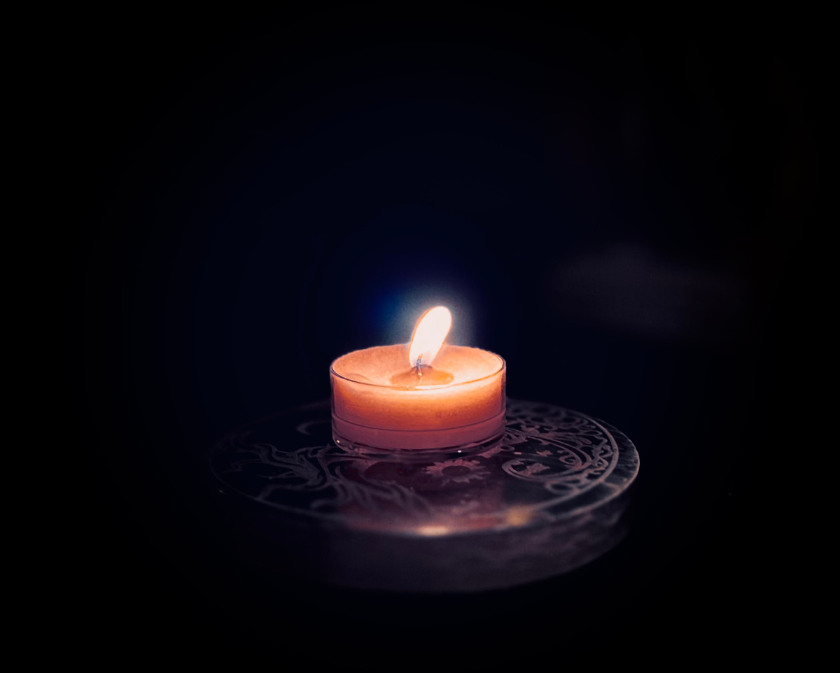 A small candle with a bright flame.